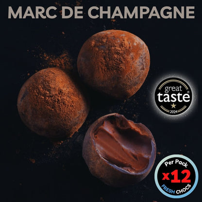 Chocolate truffles with cocoa powder on a dark background